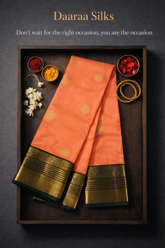 Kanchi Silks-Body-Warm Peach–Salmon Tone-Round gold zari buttas-Border-zari border-Deep olive-black undertone.