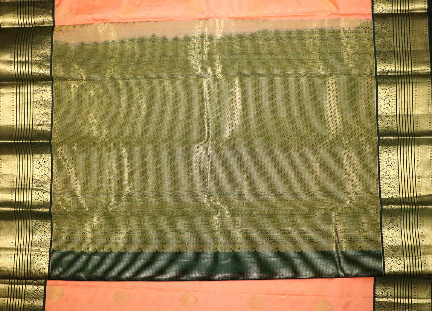 Kanchi Silks-Body-Warm Peach–Salmon Tone-Round gold zari buttas-Border-zari border-Deep olive-black undertone.
