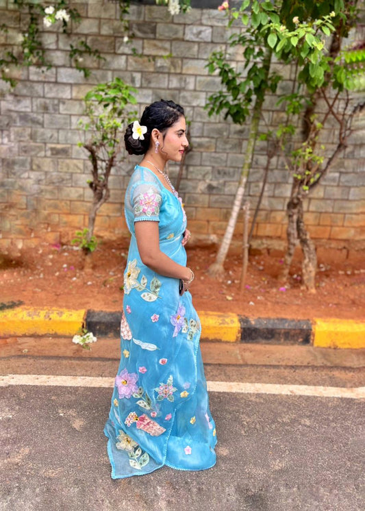 Sea blue organza saree with 3D floral appliqué and pearl sequin border