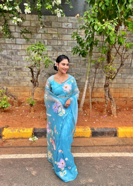 Sea blue organza saree with 3D floral appliqué and pearl sequin border